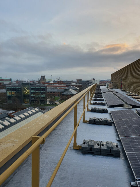 Barrial Freestanding non-penetrating rooftop guardrail system installed at Base Building, Manchester Science Park, providing safe maintenance access around rooftop solar infrastructure.