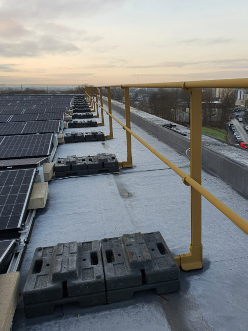 Barrial Freestanding non-penetrating rooftop guardrail system installed at Base Building, Manchester Science Park, providing safe maintenance access around rooftop solar infrastructure.